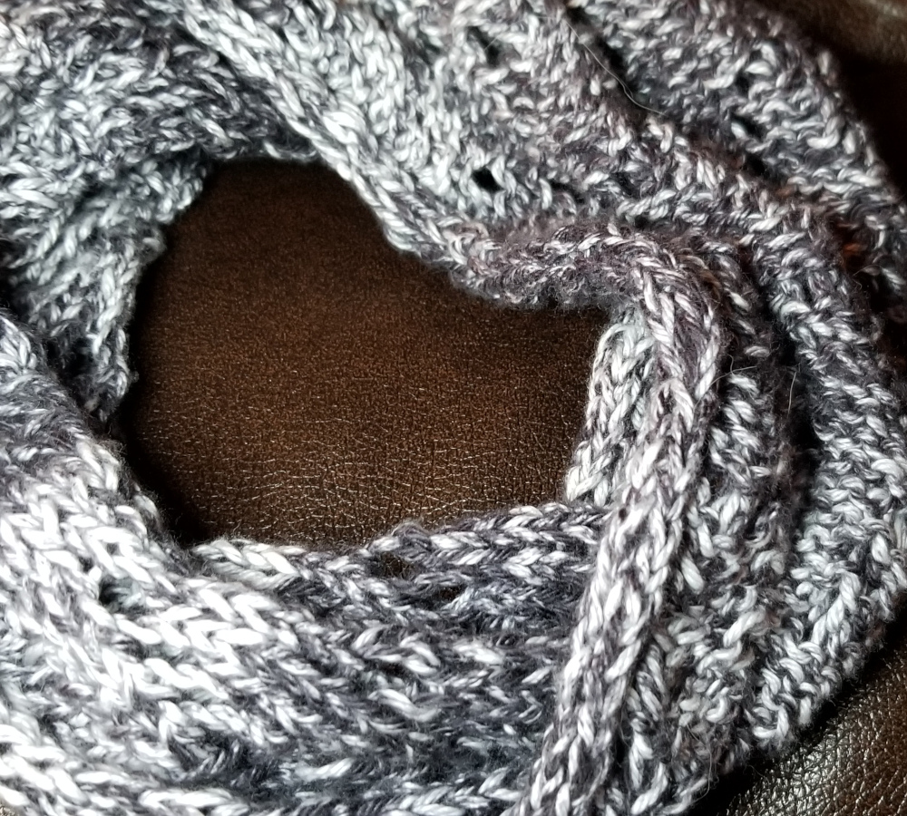 A knitted black and white cowl