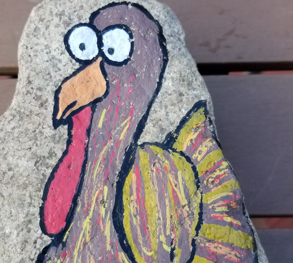 A painted rock of a turkey