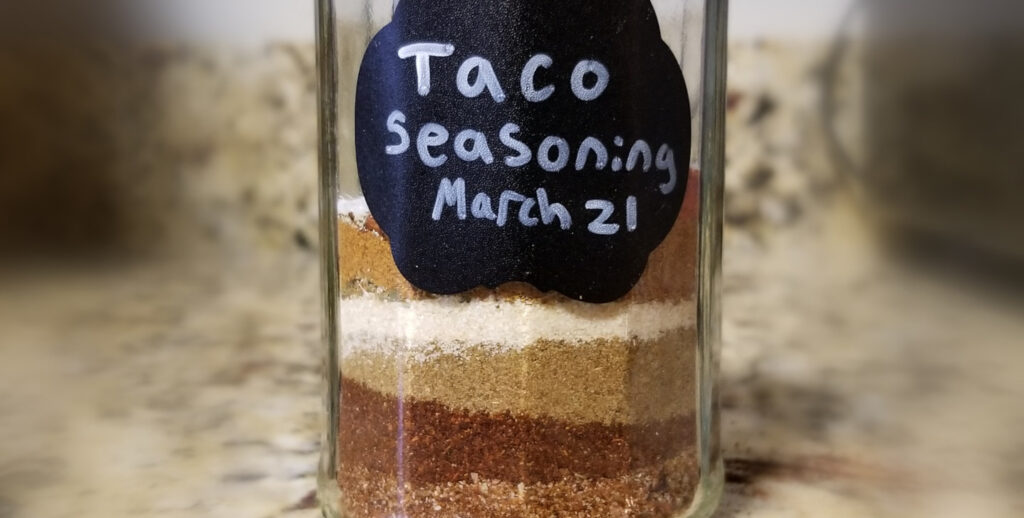 Southwest seasonings layered in a spice jar, with a name and date tag. 