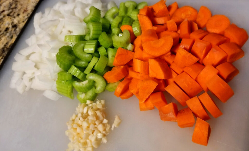 Cut up lentil Soup vegetables on a cutting board. 