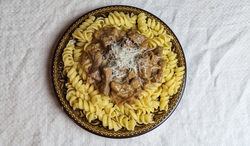 Beef stroganoff sauce over rotini noodles.