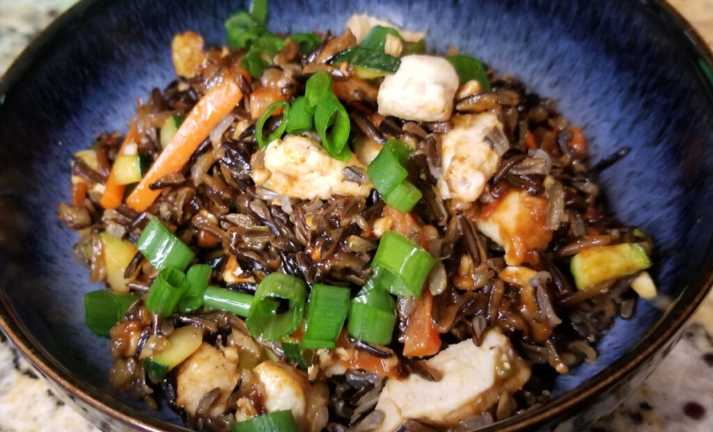 Thai style wild rice cooked and served in a blue bowl. 
