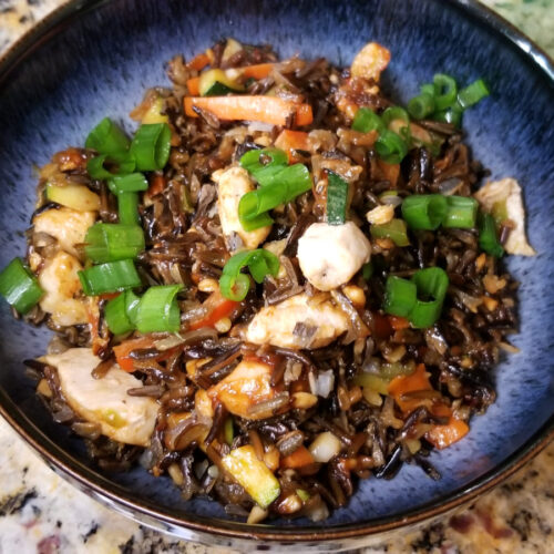 A close up of thai style wild rice in a blue bowl