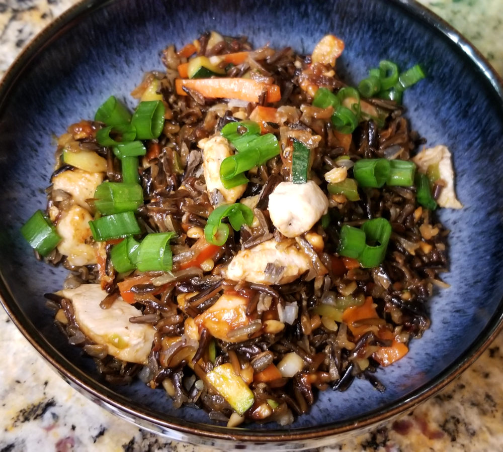A close up of thai style wild rice in a blue bowl