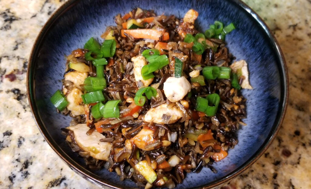 A close up of thai style wild rice in a blue bowl