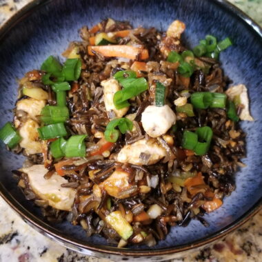 Thai style wild rice garnished with green onion.