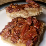 make ahead party foods: pecan pie bars stacked atop each other.