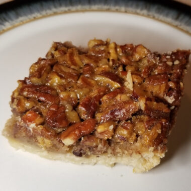 A pecan pie bar with shortbread crust.