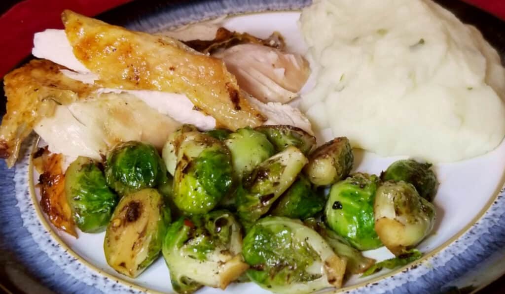 Roasted brussels sprouts served with chicken and mashed potatoes. 