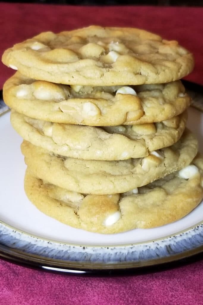 A stack of five cookies on red backdrop.