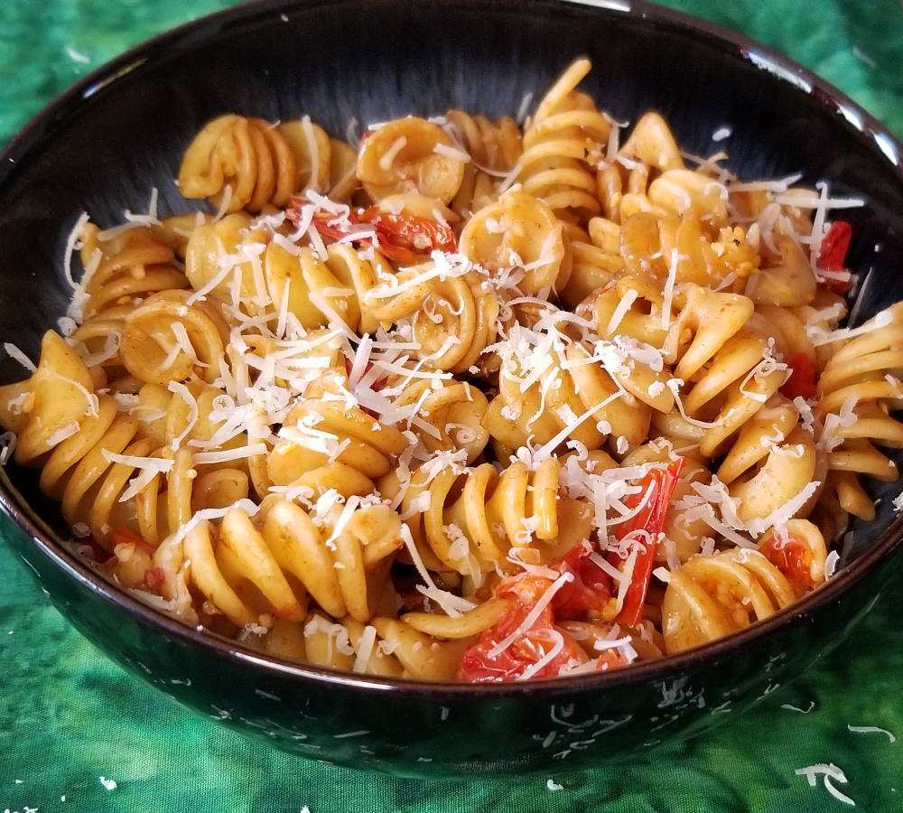 burst cherry tomato pasta in a bowl.