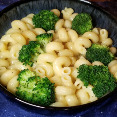 Instant pot macaroni and cheese with broccoli in a bowl.