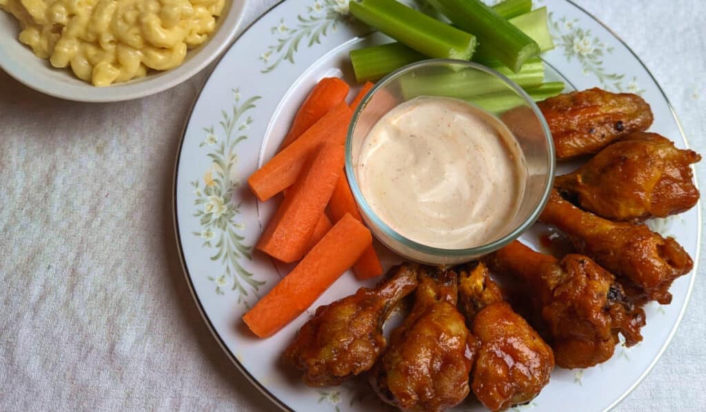 Air fried chicken wings with vegetables, ranch, and macaroni and cheese. 