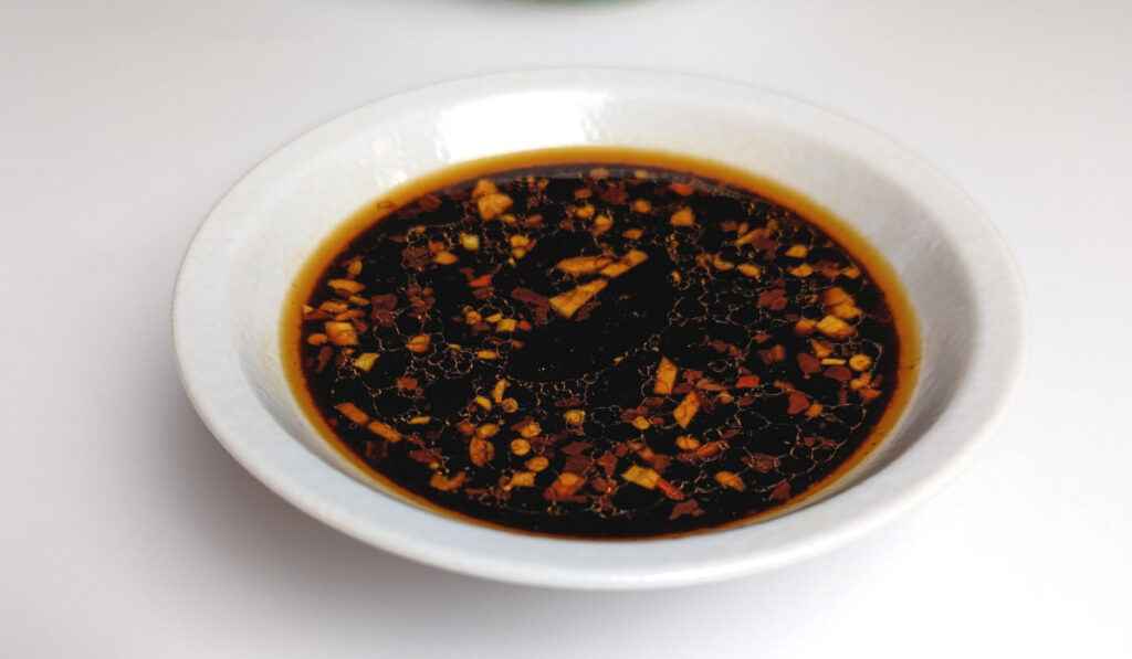 Soy sauce based stir fry sauce in a white bowl.