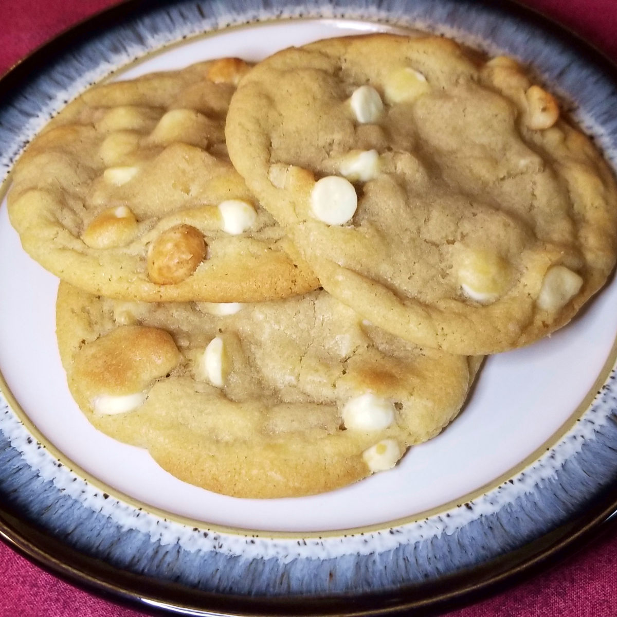 White chocolate chip macadamia nut cookies on a plate.