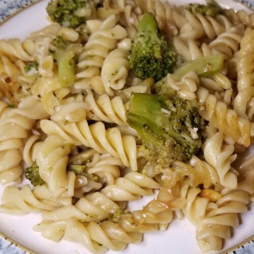 Broccoli pine nut pasta served in a plate.